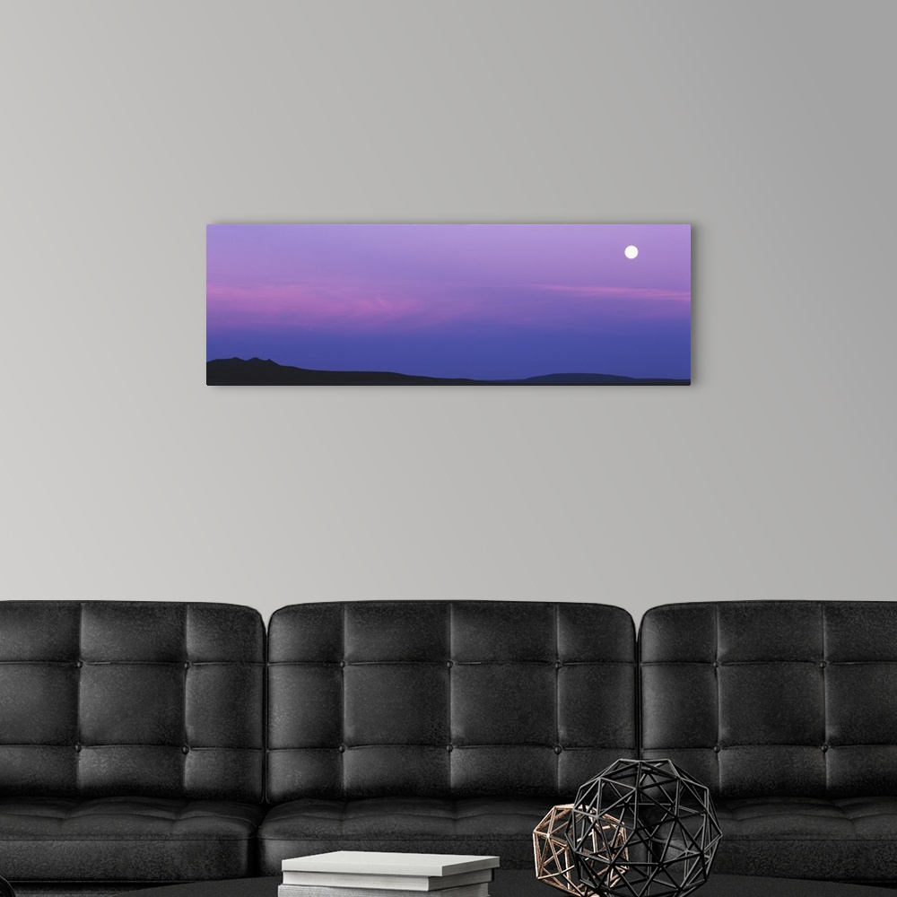 A modern room featuring Full moon setting over Tres Orejas, New Mexico