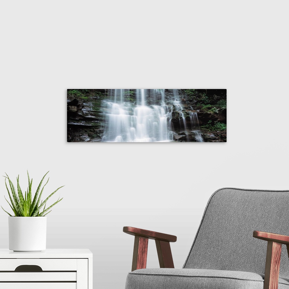A modern room featuring Panoramic photo on canvas of water rushing down a rocky cliff in Pennsylvania.