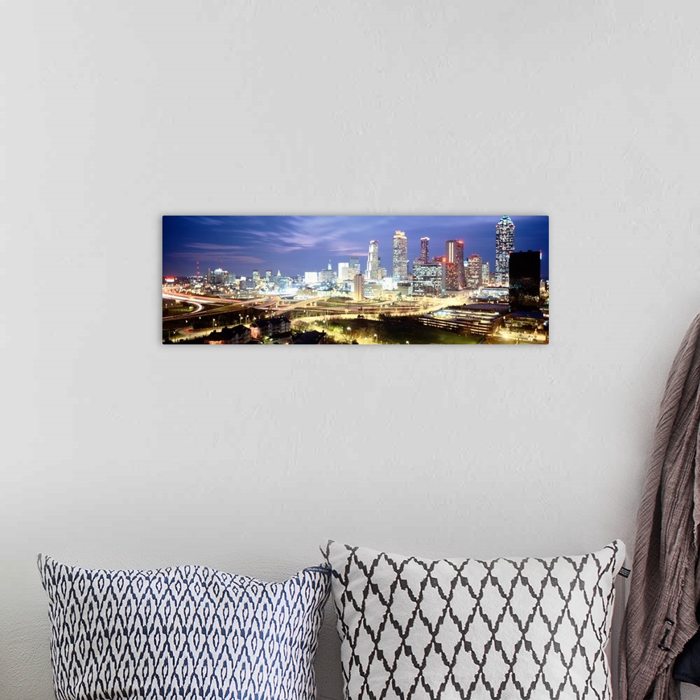 A bohemian room featuring Panoramic photograph of buildings lit up against a dusk sky.