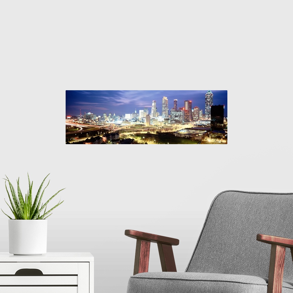 A modern room featuring Panoramic photograph of buildings lit up against a dusk sky.