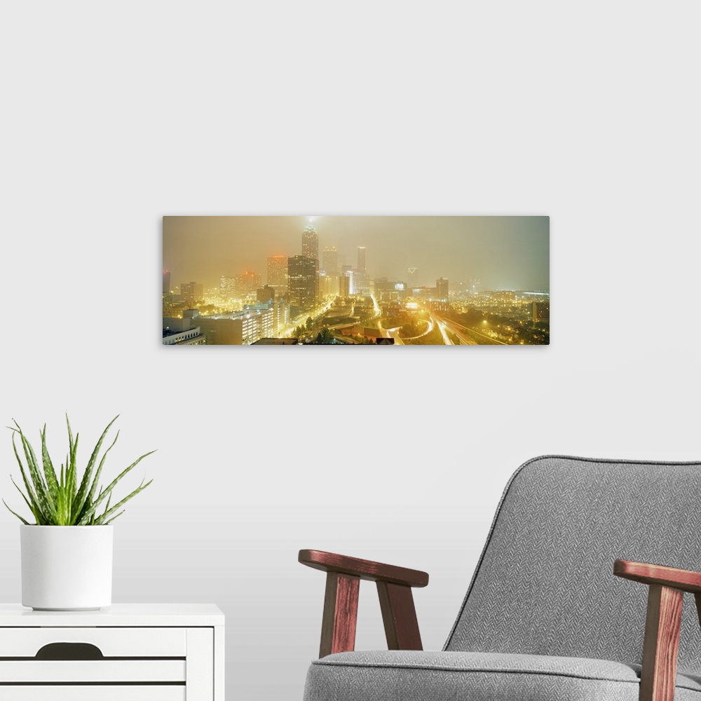A modern room featuring A time-lapsed photograph of the roads through the city and skyscrapers in the fog on a panoramic ...