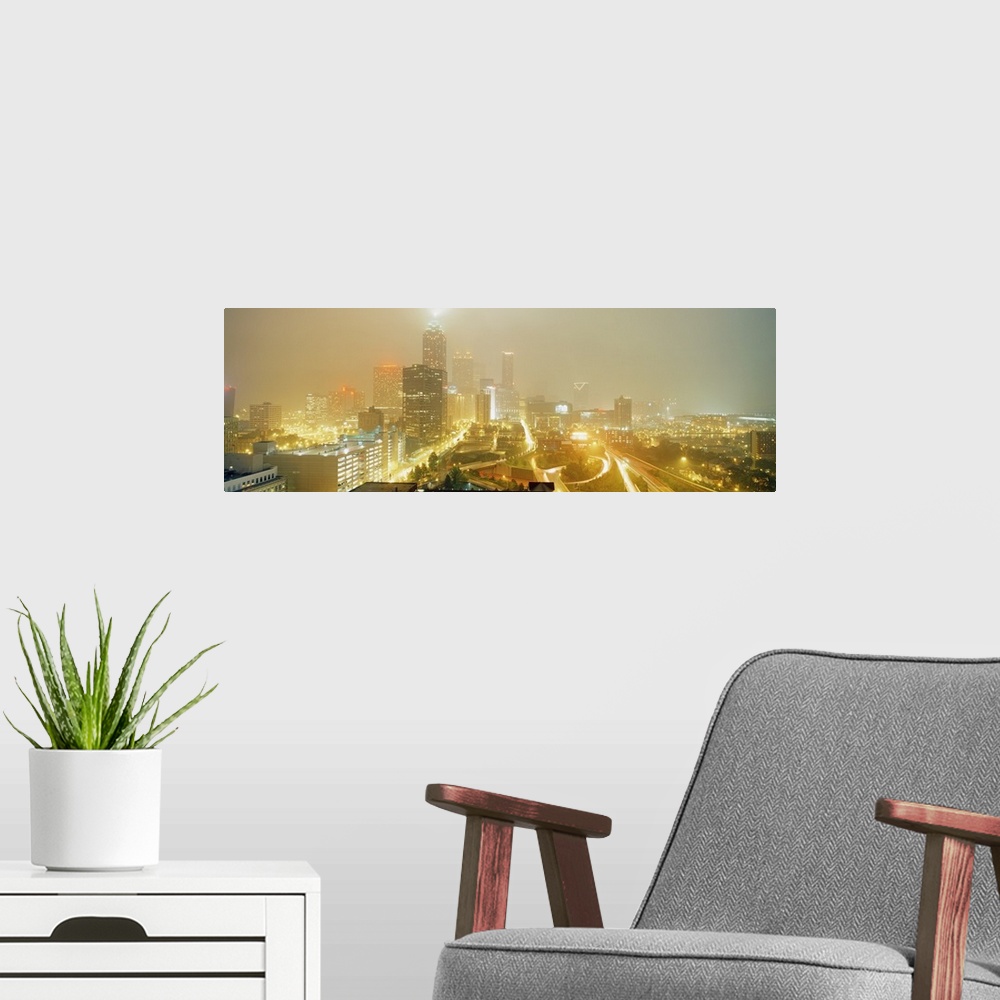 A modern room featuring A time-lapsed photograph of the roads through the city and skyscrapers in the fog on a panoramic ...