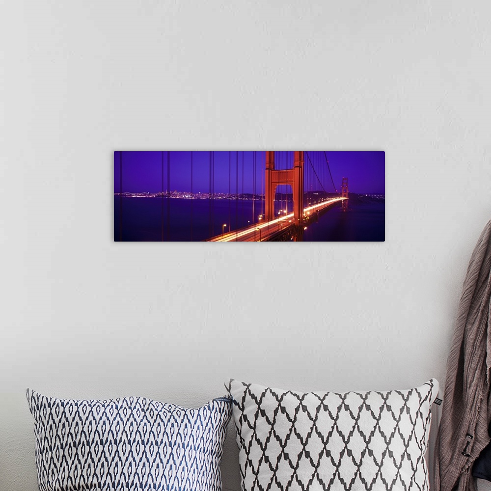 A bohemian room featuring Twilight and red hue of the Golden Gate Bridge in San Francisco, California.