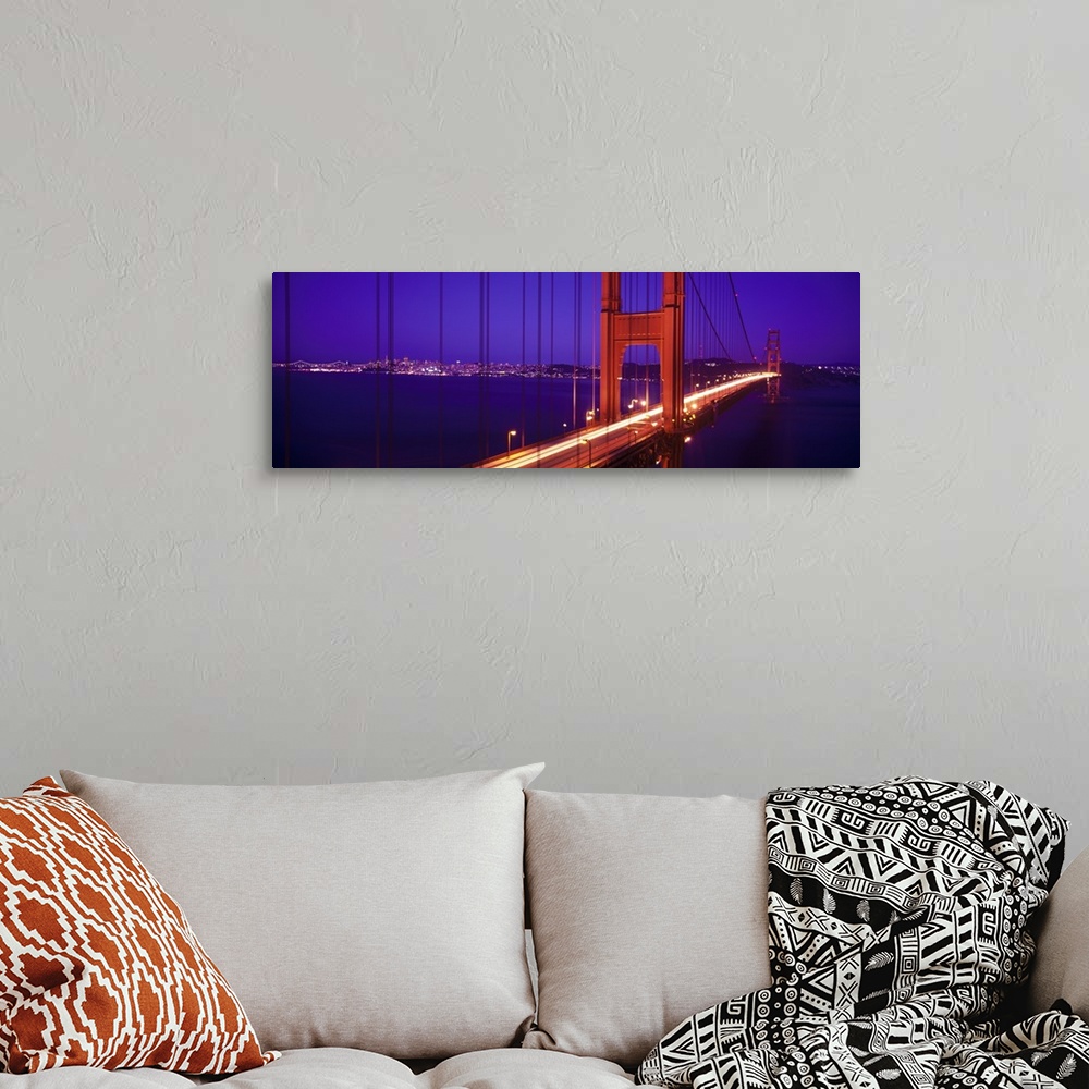 A bohemian room featuring Twilight and red hue of the Golden Gate Bridge in San Francisco, California.