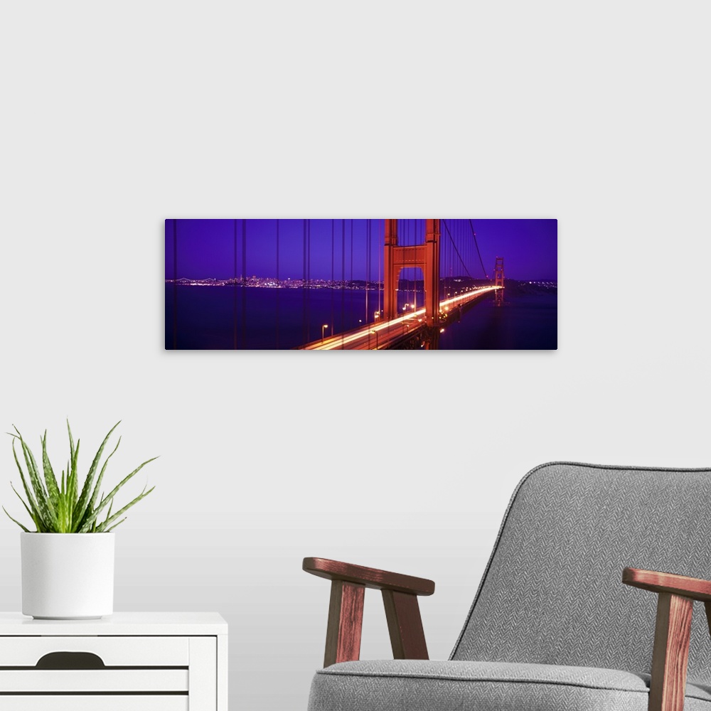 A modern room featuring Twilight and red hue of the Golden Gate Bridge in San Francisco, California.