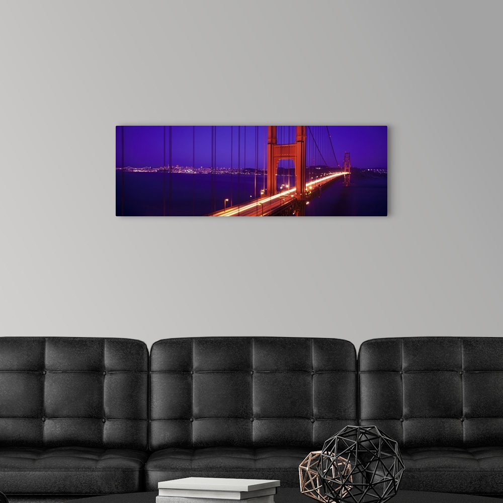 A modern room featuring Twilight and red hue of the Golden Gate Bridge in San Francisco, California.