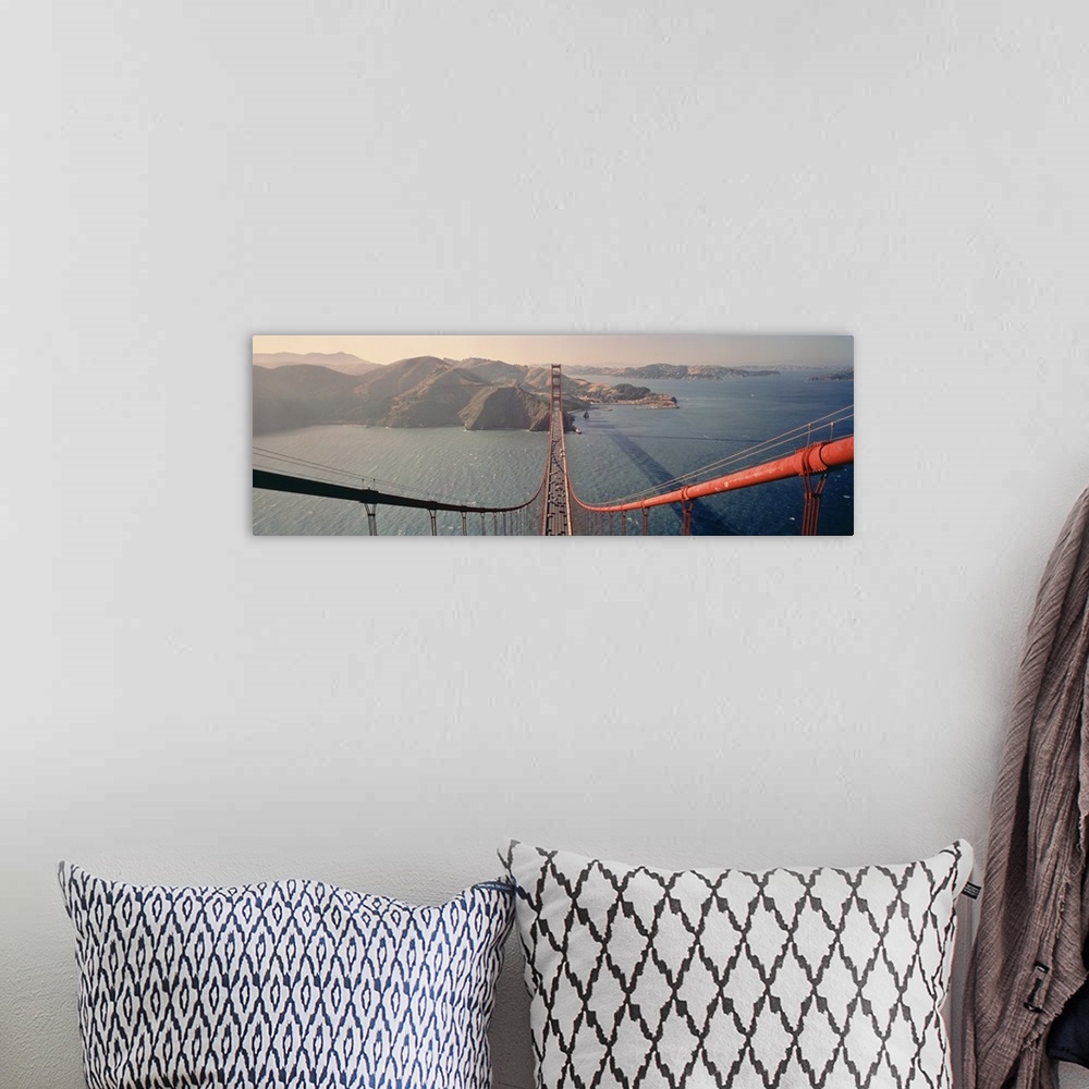 A bohemian room featuring A wide angle photograph taken from on top of the golden gate bridge while looking down the cables...
