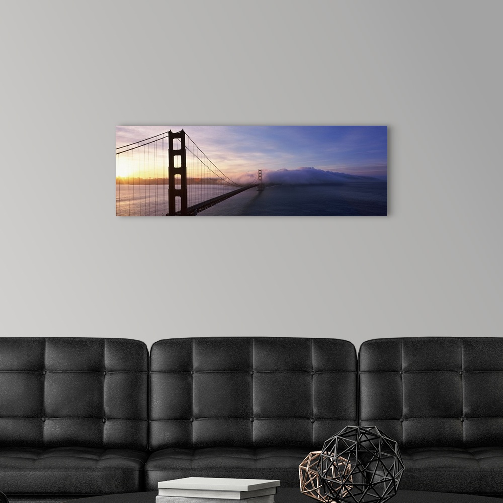 A modern room featuring The Golden Gate Bridge is photographed in panoramic view looking from one end down to the other w...