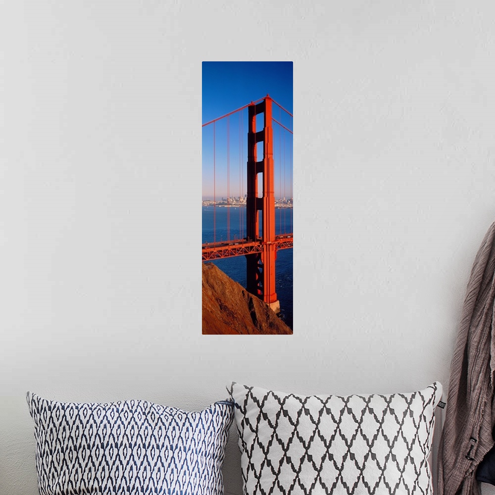 A bohemian room featuring Tall panoramic photo of on of the main portions of the Golden Gate Bridge with cars driving acros...