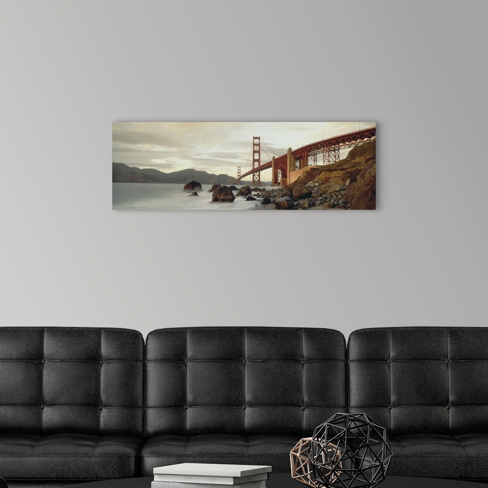 A modern room featuring Panoramic photograph shows a body of water slowly crashing into the rocky shores that sit next to...
