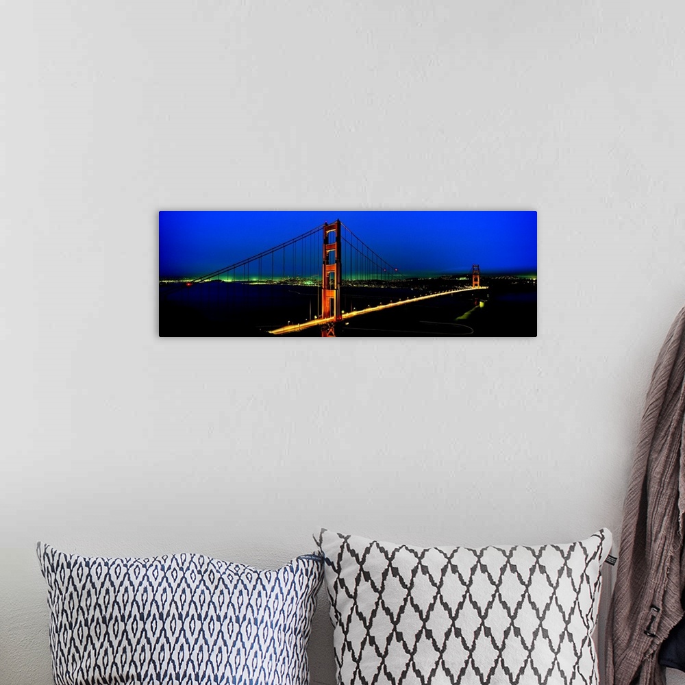 A bohemian room featuring The Golden Gate Bridge and California coast lit up at night.