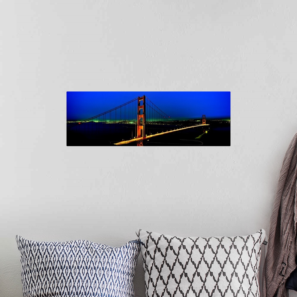 A bohemian room featuring The Golden Gate Bridge and California coast lit up at night.