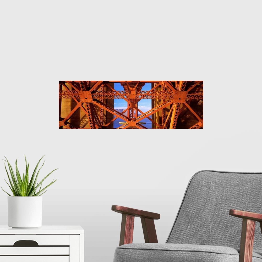 A modern room featuring Closeup artwork of the Golden Gate Bridge in San Francisco, California (CA). A large ship and mou...