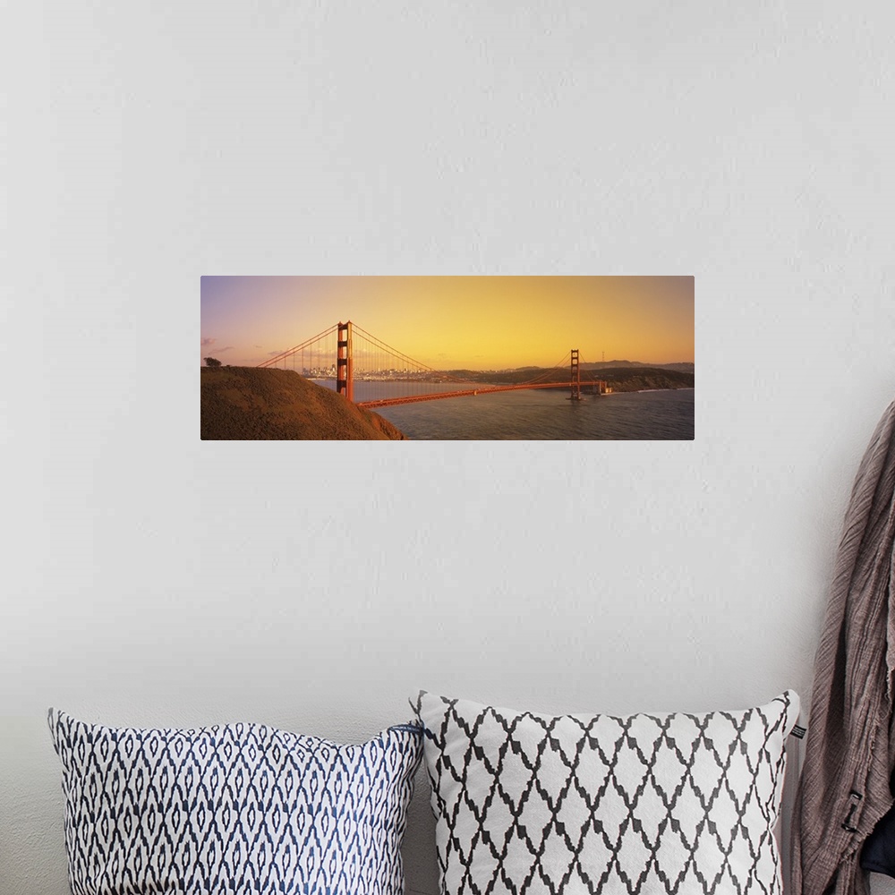 A bohemian room featuring Panoramic photo of the Golden Gate Bridge with a bright sky and the city in the distance.