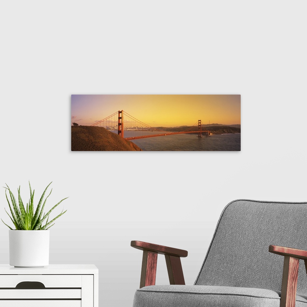 A modern room featuring Panoramic photo of the Golden Gate Bridge with a bright sky and the city in the distance.