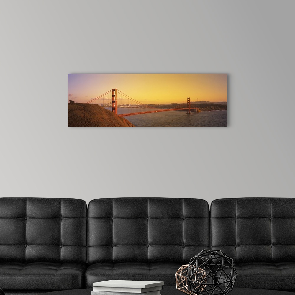 A modern room featuring Panoramic photo of the Golden Gate Bridge with a bright sky and the city in the distance.