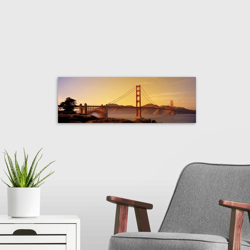 A modern room featuring Giant horizontal photograph of San Francisco Bay's suspension bridge, the Golden Gate Bridge, at ...