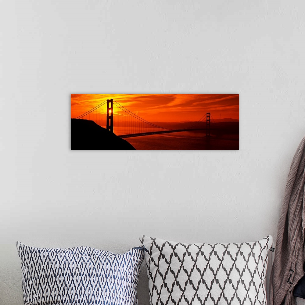 A bohemian room featuring This oversized wall art is a panorama of San Francisco Bay at sunset where the suspension bridge ...