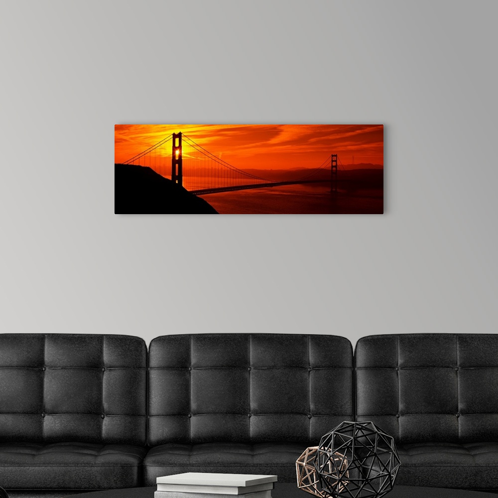 A modern room featuring This oversized wall art is a panorama of San Francisco Bay at sunset where the suspension bridge ...