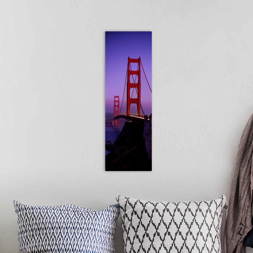 A bohemian room featuring Oversized, vertical photograph taken at an angle of the Golden Gate Bridge at dusk, in San Franci...