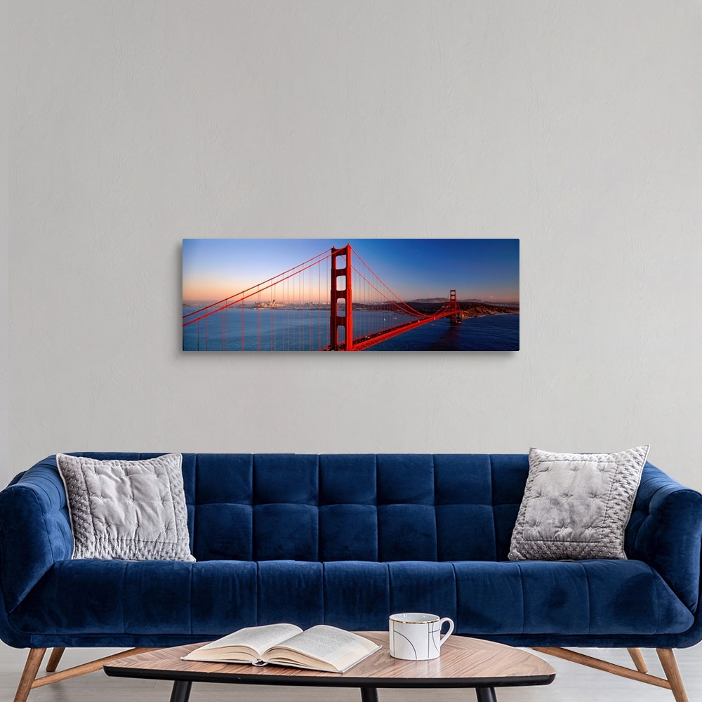 A modern room featuring Big landscape photograph of the Golden Gate Bridge extending over the blue waters of the San Fran...