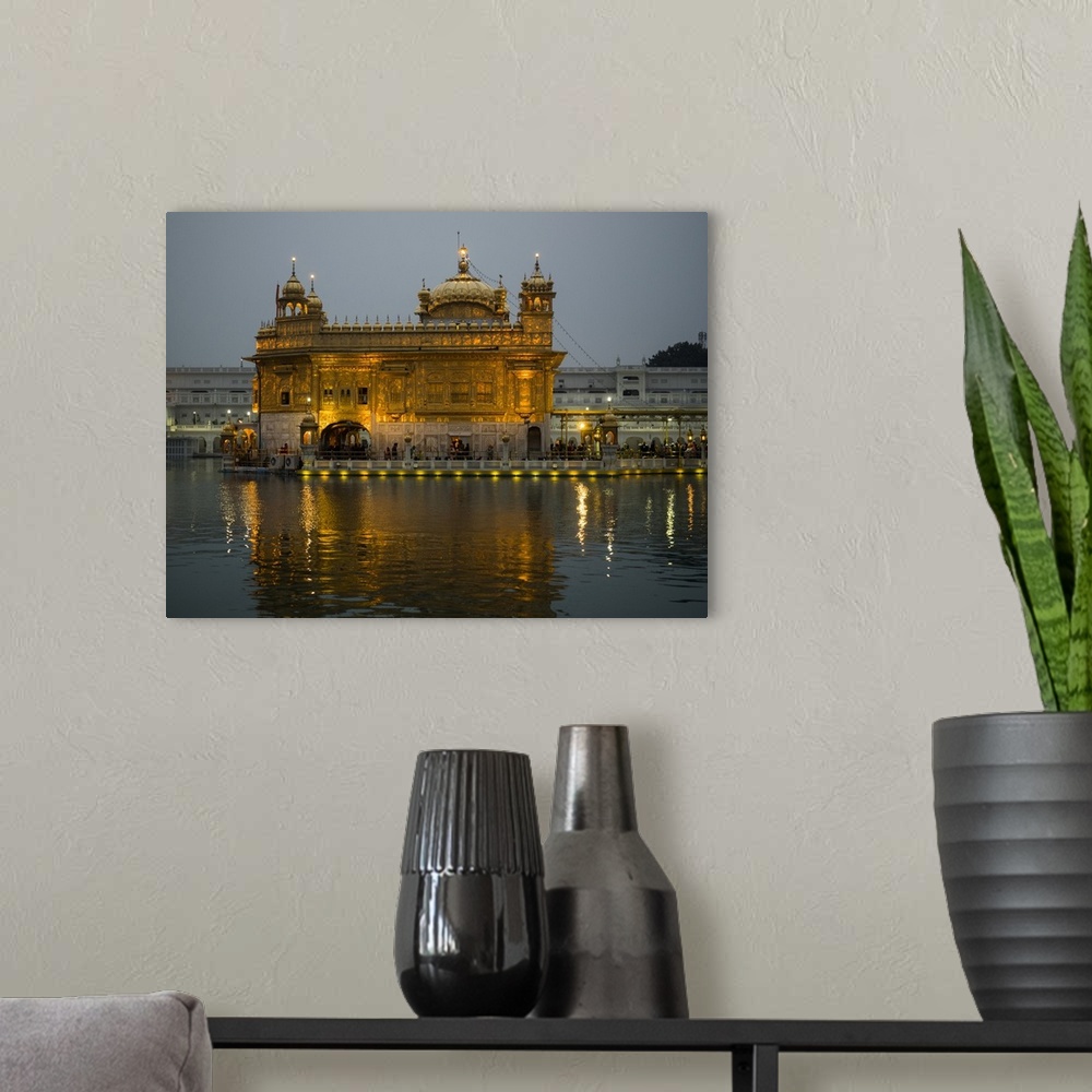A modern room featuring Golden Temple reflected in pool, Amritsar, Punjab, India.