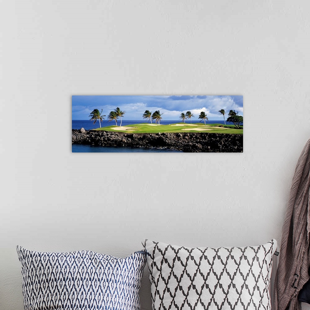 A bohemian room featuring Panoramic photograph of golf course on a rock cliff stretching into the ocean on a cloudy day.  T...