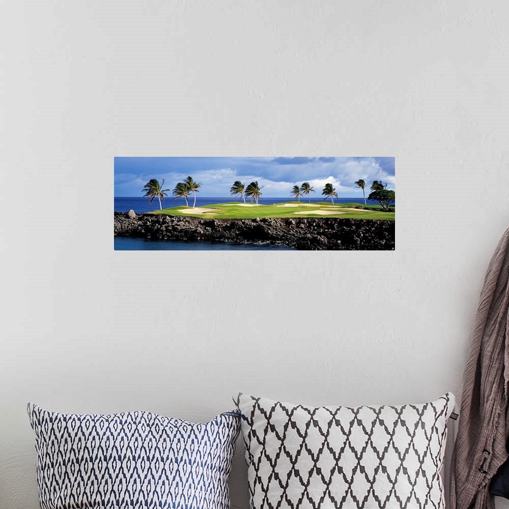 A bohemian room featuring Panoramic photograph of golf course on a rock cliff stretching into the ocean on a cloudy day.  T...