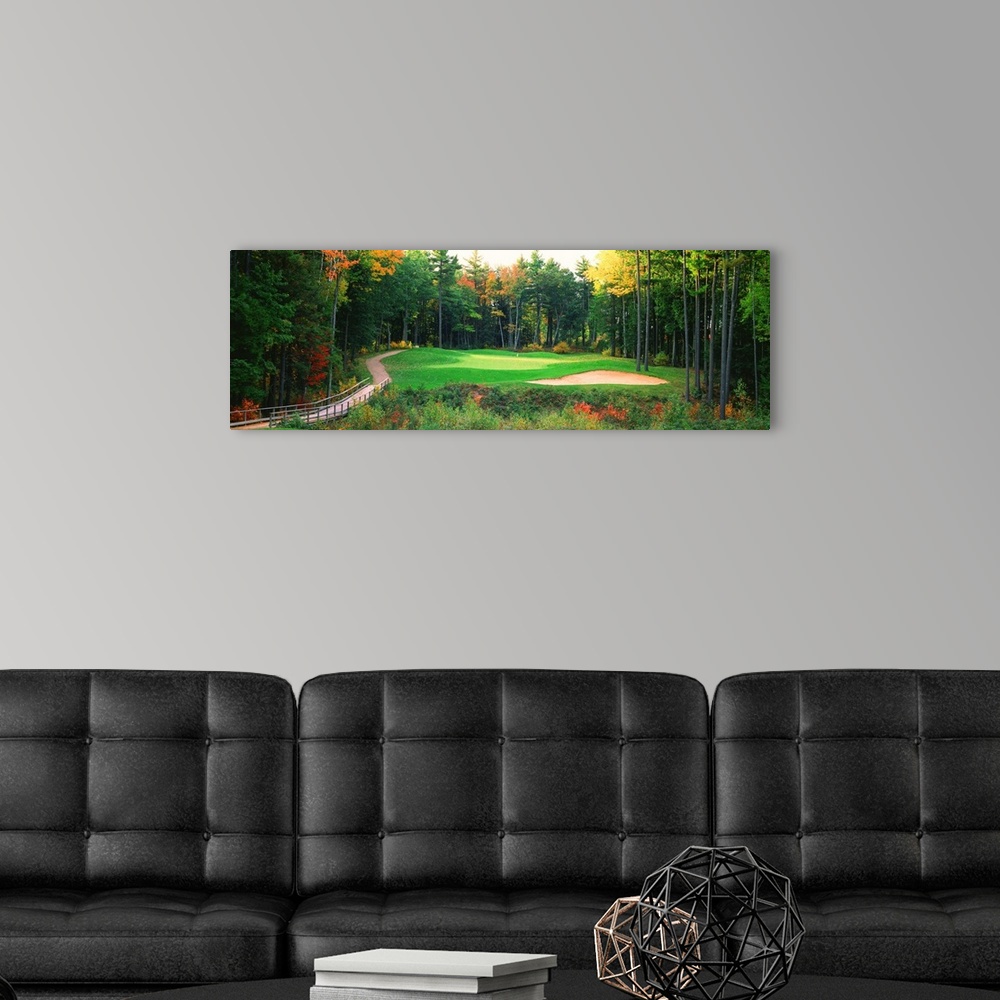 A modern room featuring Panoramic photo of a golf green in the Northern United States. A wooden bridge leads to the hole ...