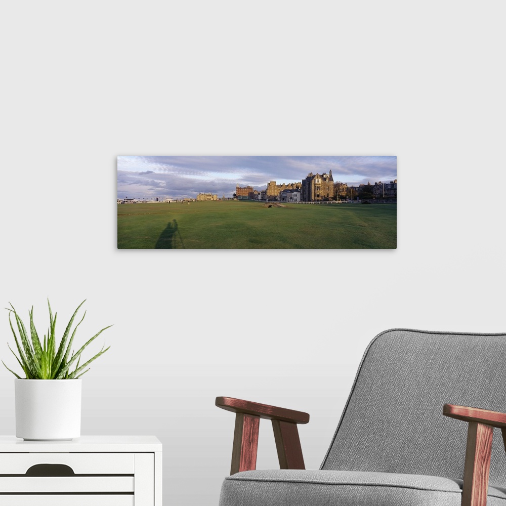 A modern room featuring Golf course with buildings in the background, The Royal and Ancient Golf Club, St. Andrews, Fife,...