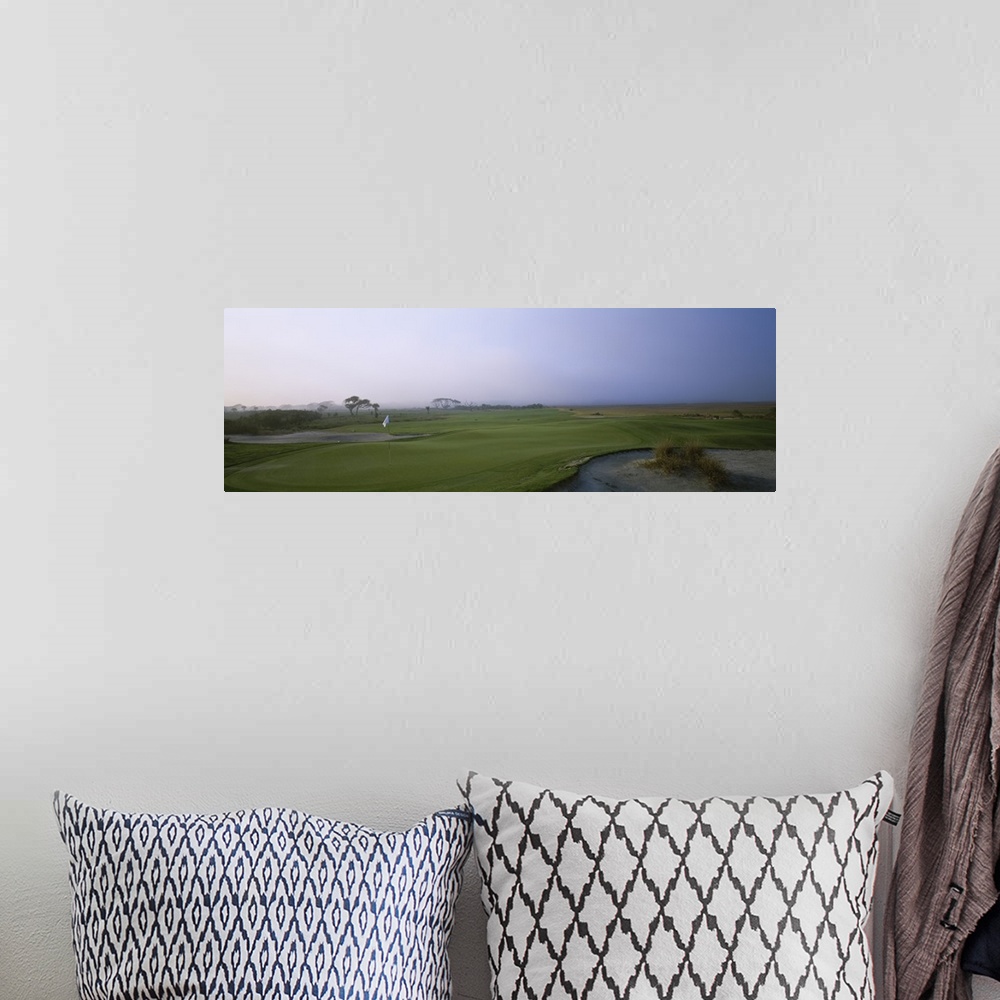 A bohemian room featuring Giant landscape photograph of a flag surrounded by the rolling greens on Ocean Golf Course, benea...