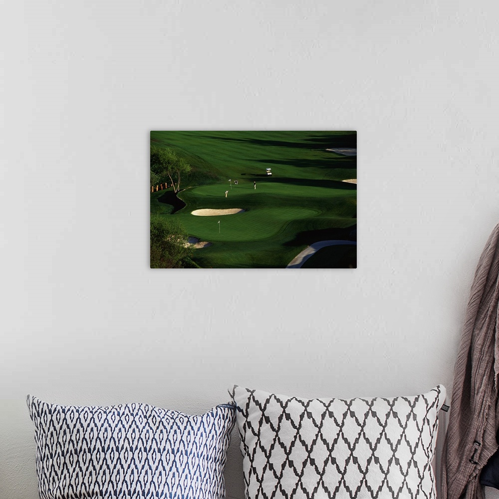 A bohemian room featuring This decorative wall art is an aerial photograph of a California golf course in a landscape scene.