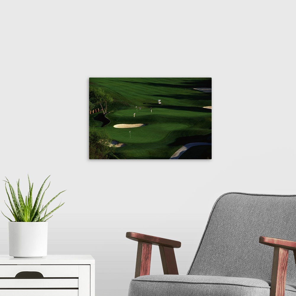 A modern room featuring This decorative wall art is an aerial photograph of a California golf course in a landscape scene.