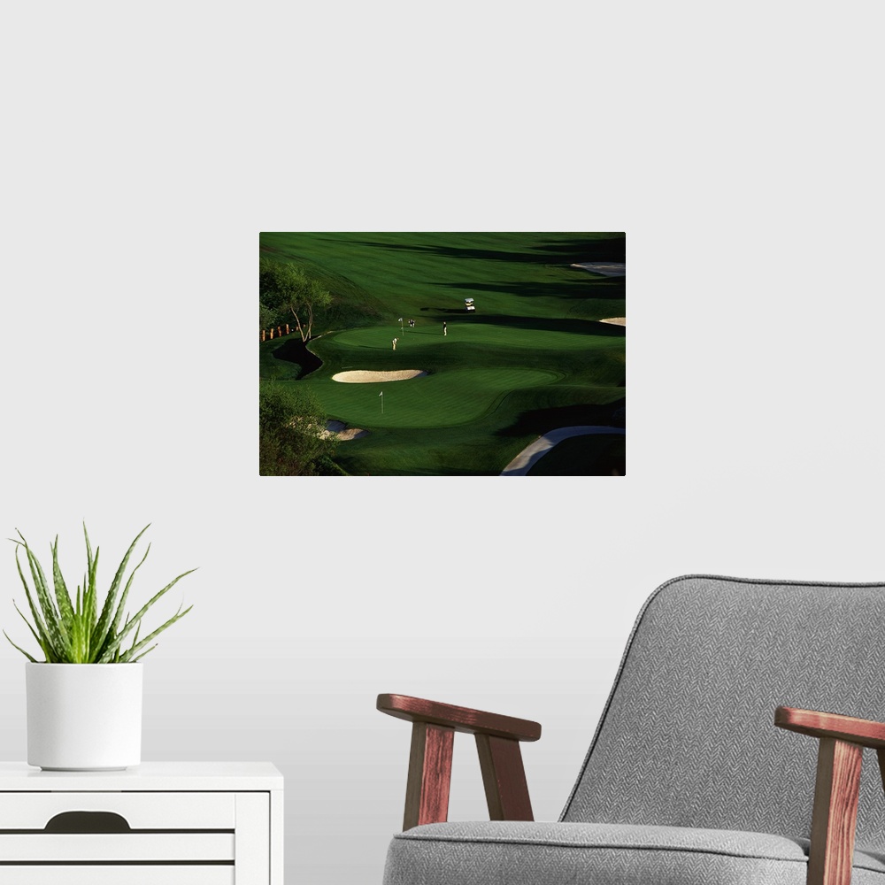 A modern room featuring This decorative wall art is an aerial photograph of a California golf course in a landscape scene.