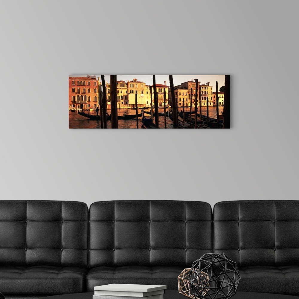 A modern room featuring Panoramic photo of buildings along the canal in Venice, Italy at sunset.