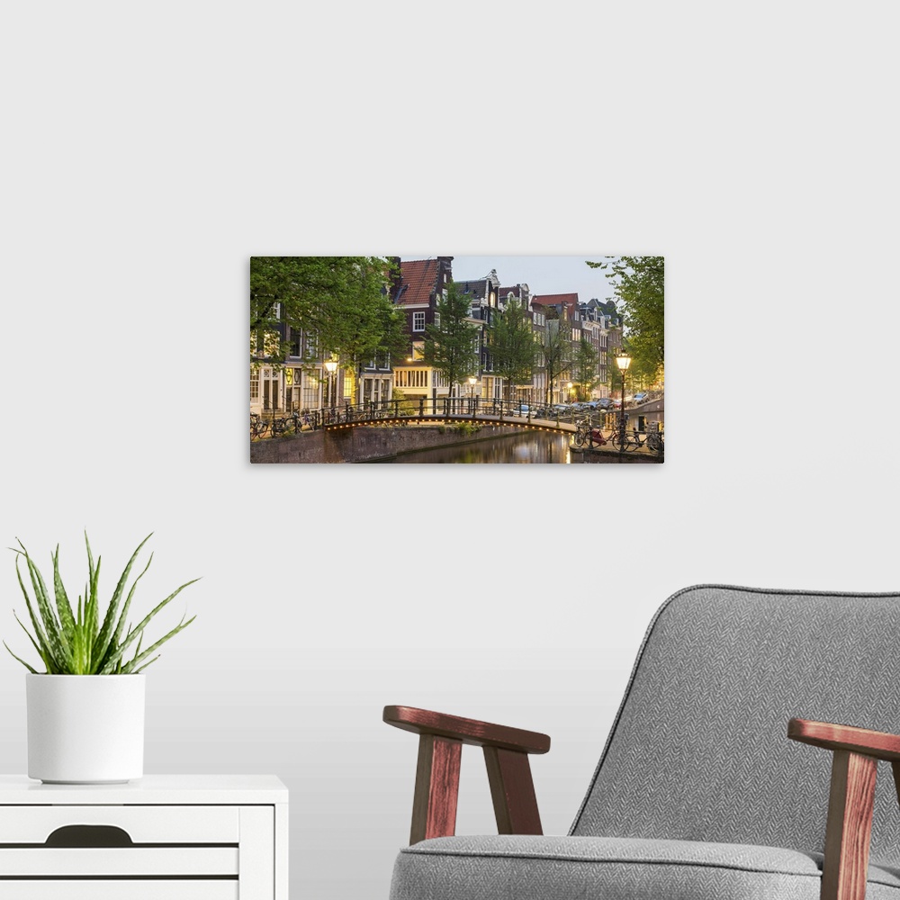 A modern room featuring Bridge over Brouwersgracht in western Grachtengordel canal ring at dusk, Amsterdam, North Holland...