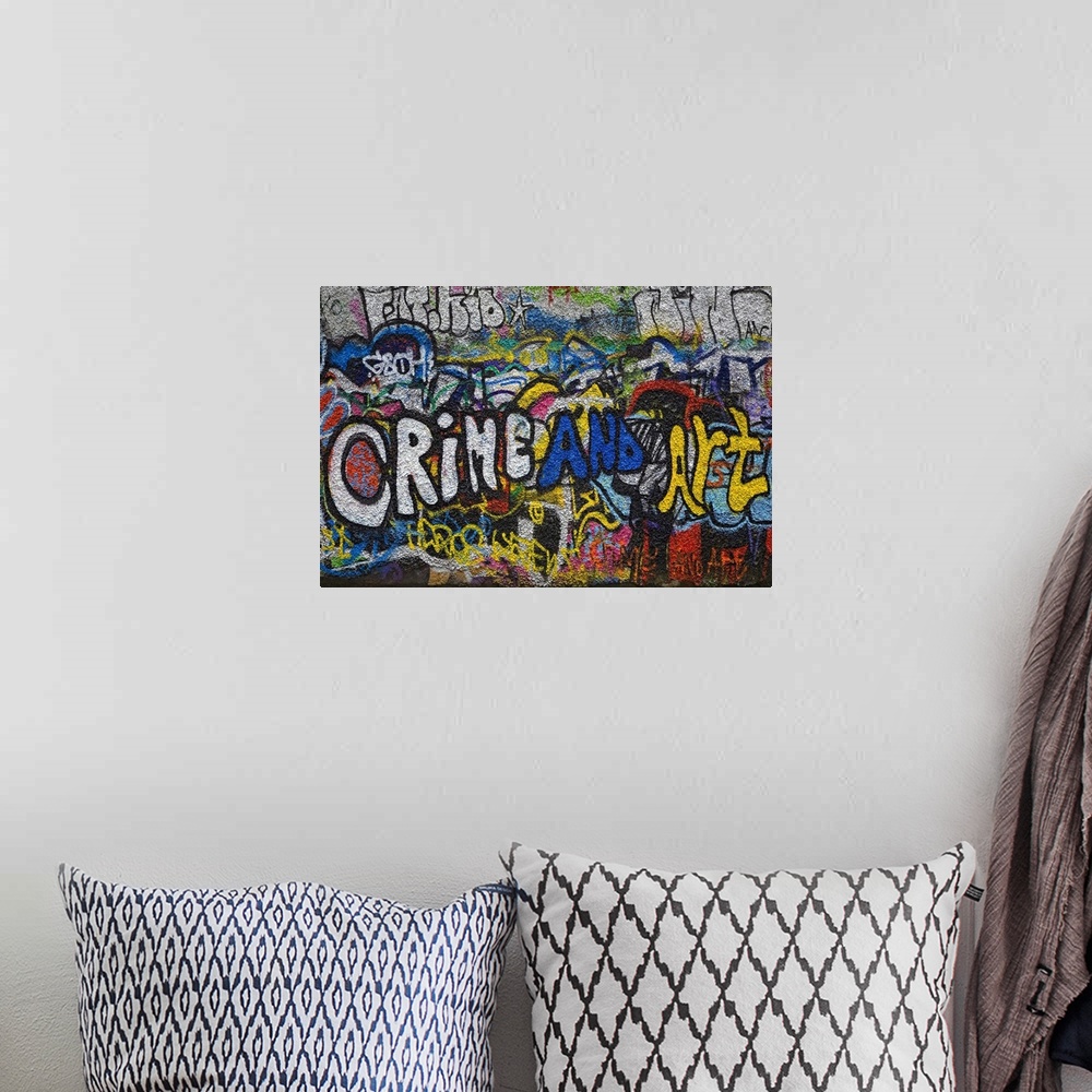 A bohemian room featuring Panoramic photograph of colorful spray painted street art on a brick wall.