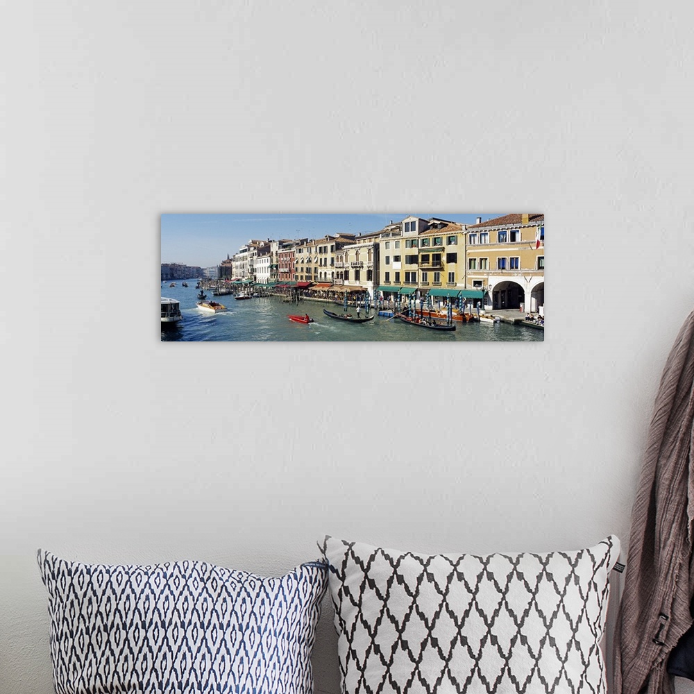 A bohemian room featuring Buildings that line part of the Grand Canal are pictured in wide angle view with various types of...