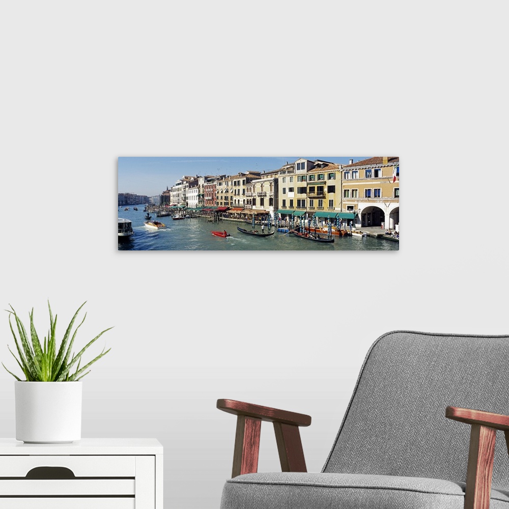 A modern room featuring Buildings that line part of the Grand Canal are pictured in wide angle view with various types of...