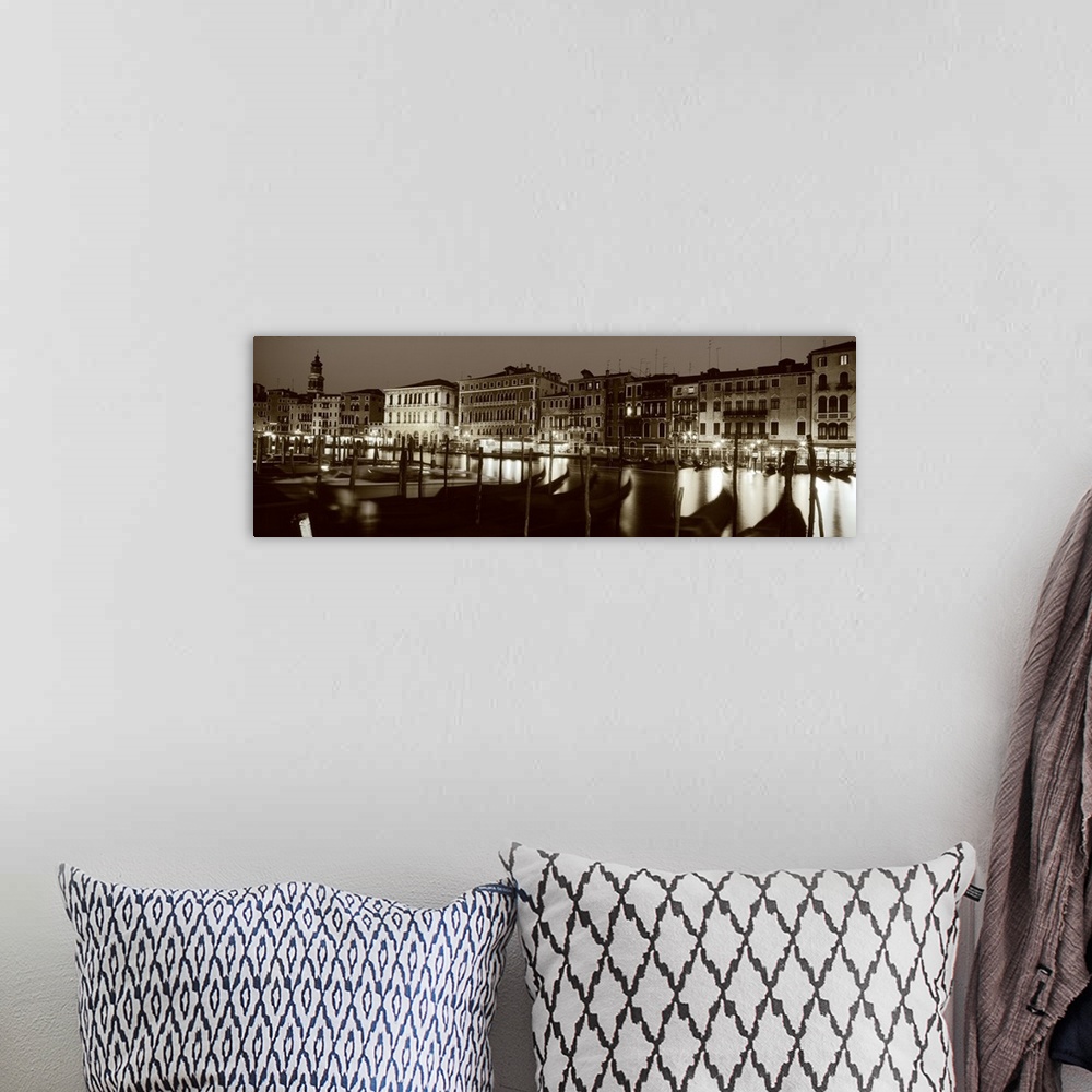 A bohemian room featuring Panoramic photograph of the Grand Canal in Venica, Italy. A line of gondola boats are tied to a d...