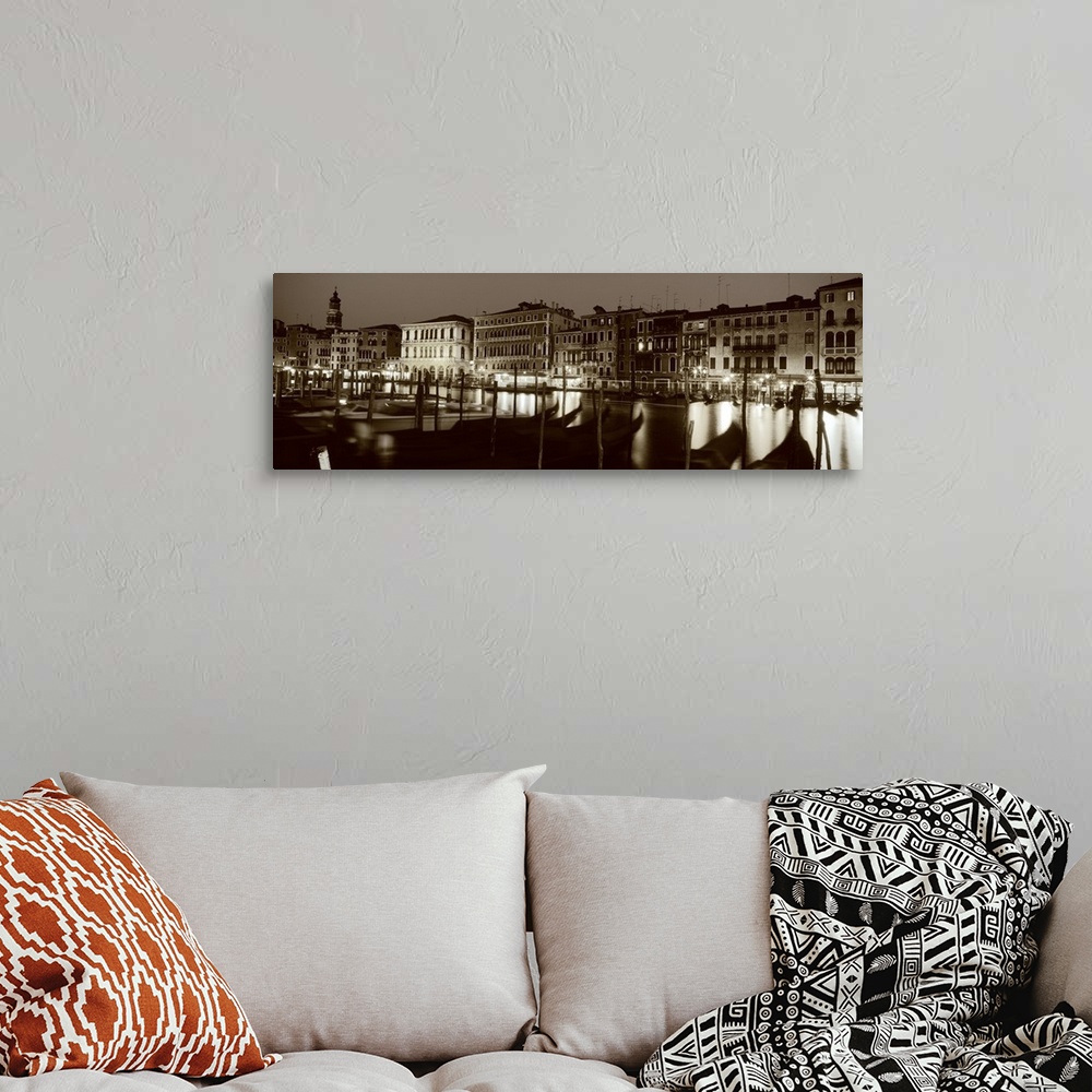 A bohemian room featuring Panoramic photograph of the Grand Canal in Venica, Italy. A line of gondola boats are tied to a d...