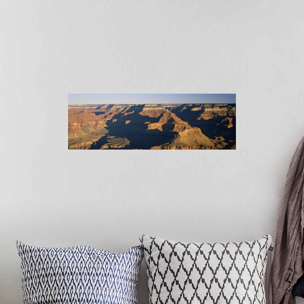 A bohemian room featuring Panoramic photograph of the large rock formations of the Grand Canyon in the golden sunlight, in ...