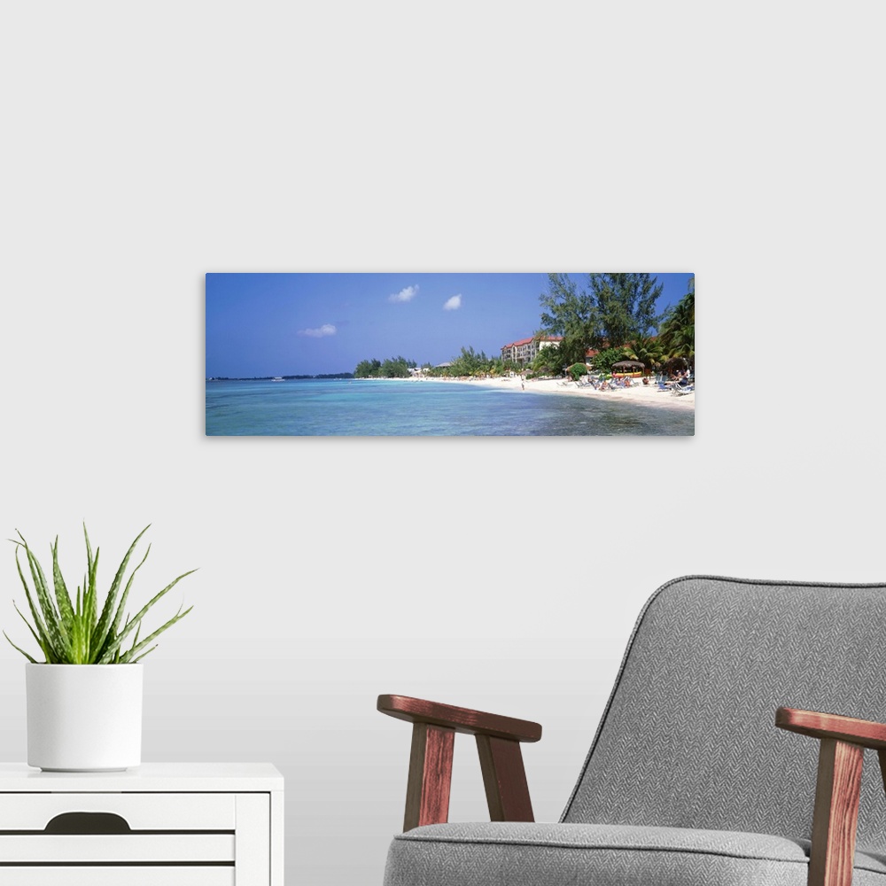 A modern room featuring Grand Cayman, Cayman Islands, 7 Mile Beach, Tourists on the beach