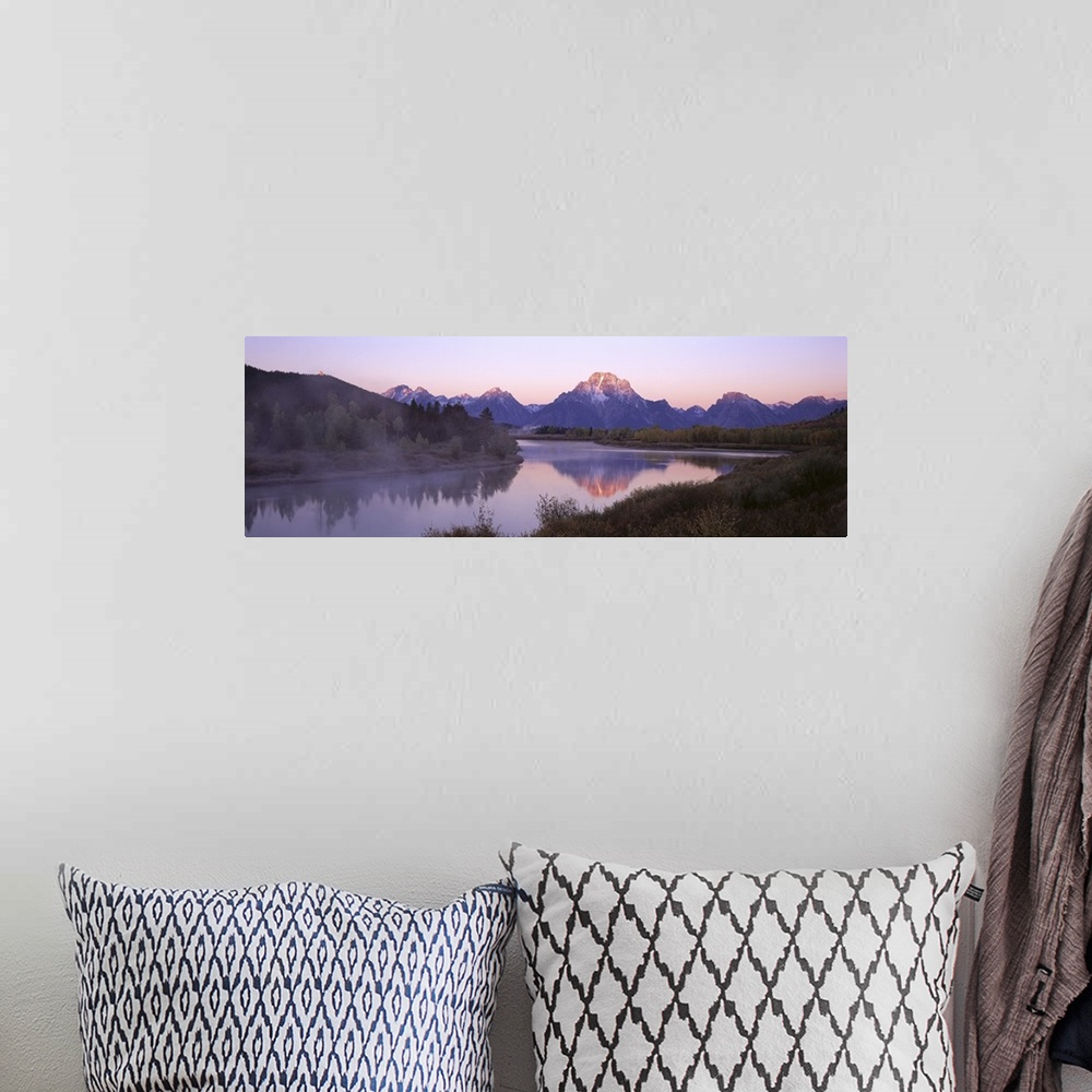 A bohemian room featuring Wide angle photograph taken from across a body of water looking out at a mountain range during su...