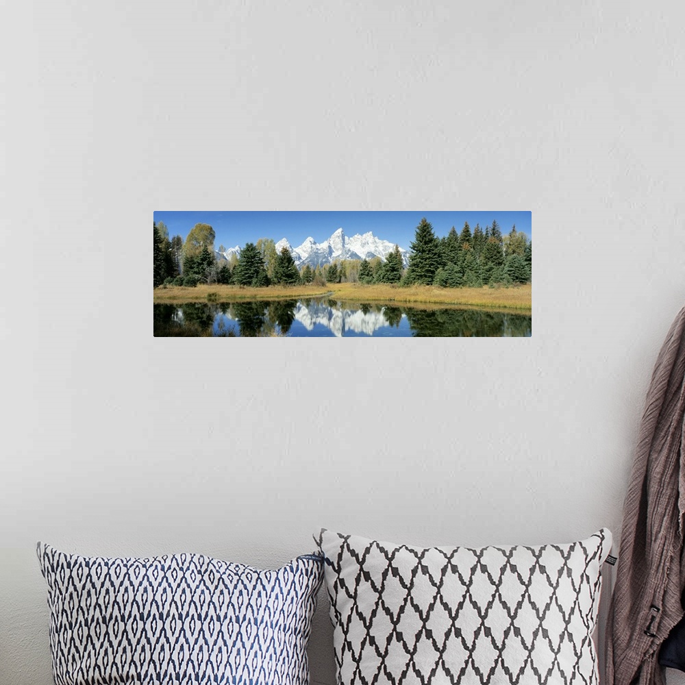 A bohemian room featuring This panoramic shot is perfect for the home or office of a national park with a body of water in ...