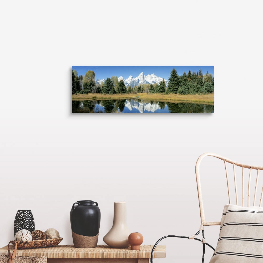 A farmhouse room featuring This panoramic shot is perfect for the home or office of a national park with a body of water in ...
