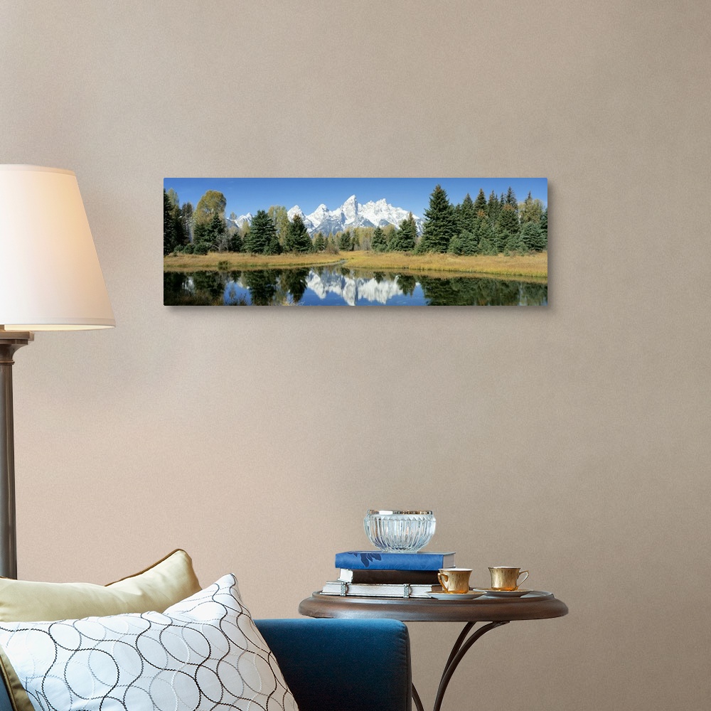 A traditional room featuring This panoramic shot is perfect for the home or office of a national park with a body of water in ...