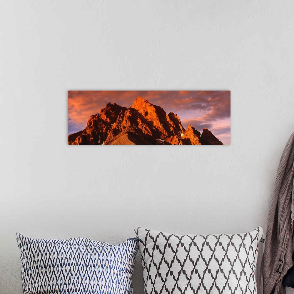 A bohemian room featuring Panoramic photograph of huge rock formation under a cloudy sky at dusk.