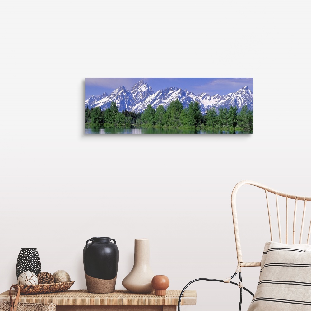 A farmhouse room featuring Panoramic photograph of snow covered mountains being a line of pine trees at the waters edge, in ...