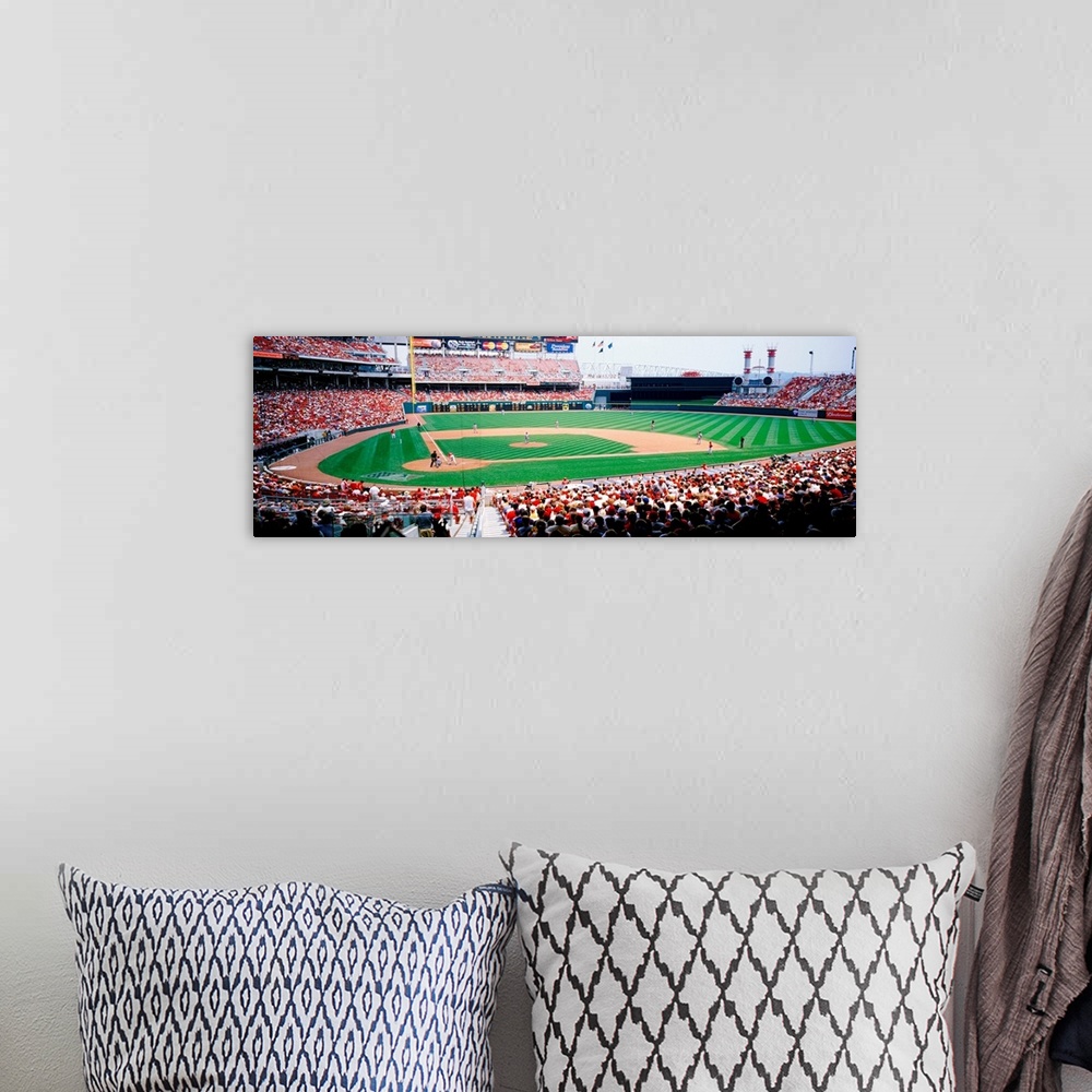A bohemian room featuring A crowded baseball stadium photograph from near home plate on a panoramic canvas.